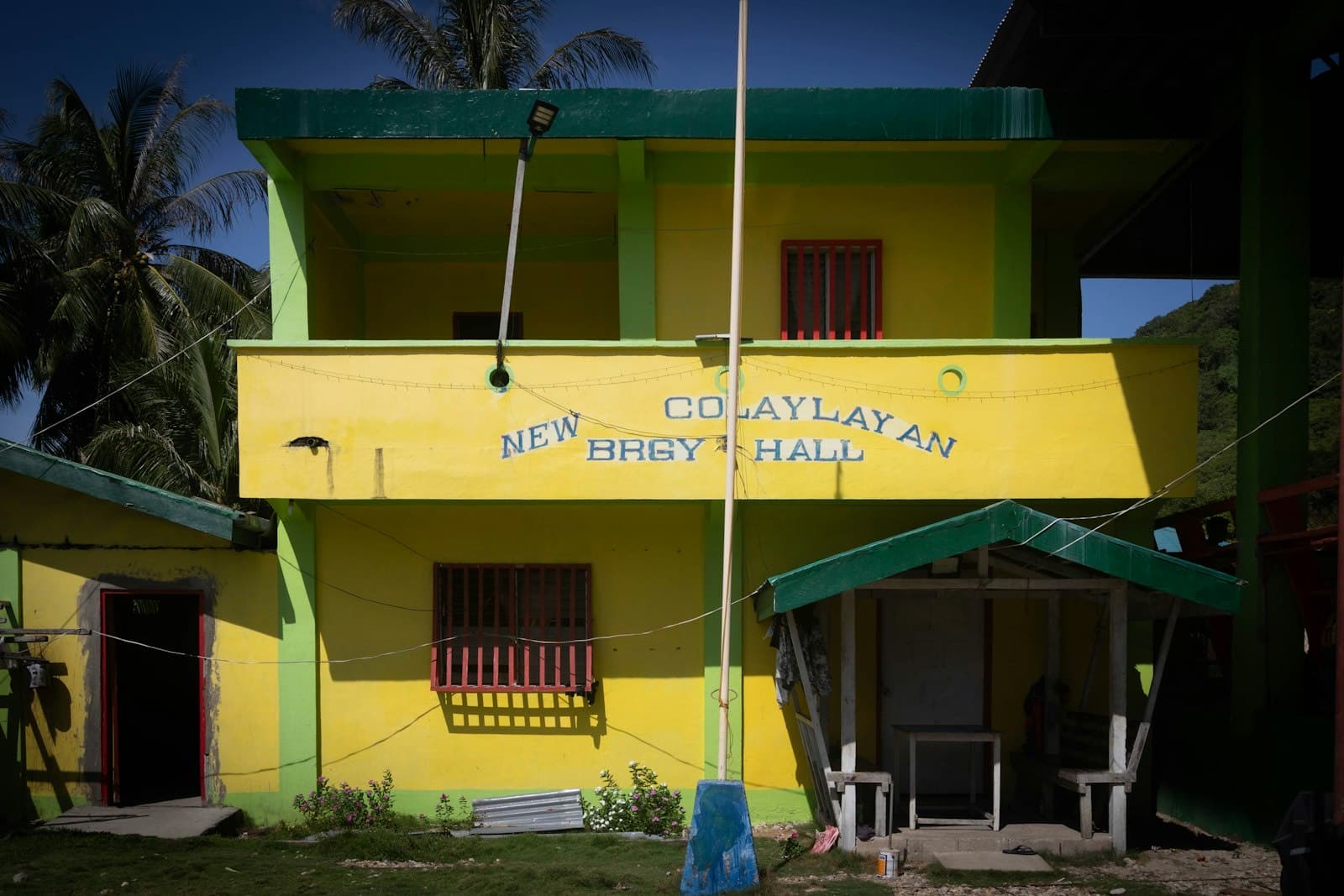 A yellow and green two-storey barangay hall in New Culaylayan, Linapacan, Palawan