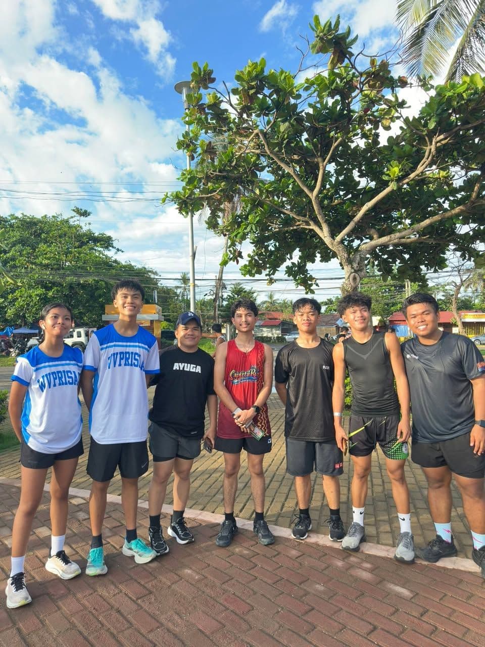Runners in race shirts posing before the HalaRUN for Juan community run
